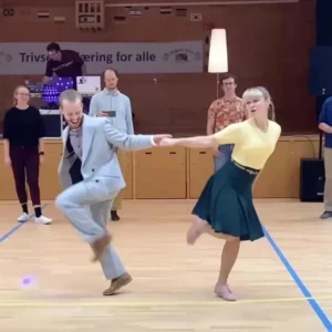 This couple’s colorful dance performance to a 1950s hit captivates the crowd…