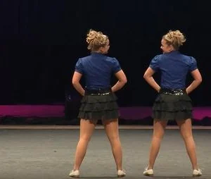 The sisters who dance clogs are like mirror images as they command the stage with their lightning-fast moves…