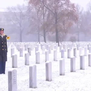 U.S. Army bugler performs “Taps” at Arlington Cemetery in the snow