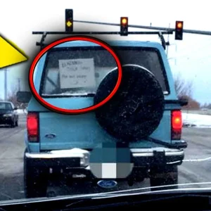 Frustrated Mom is caught behind a slow-moving automobile in traffic… then she takes a picture of the sign in their window, and